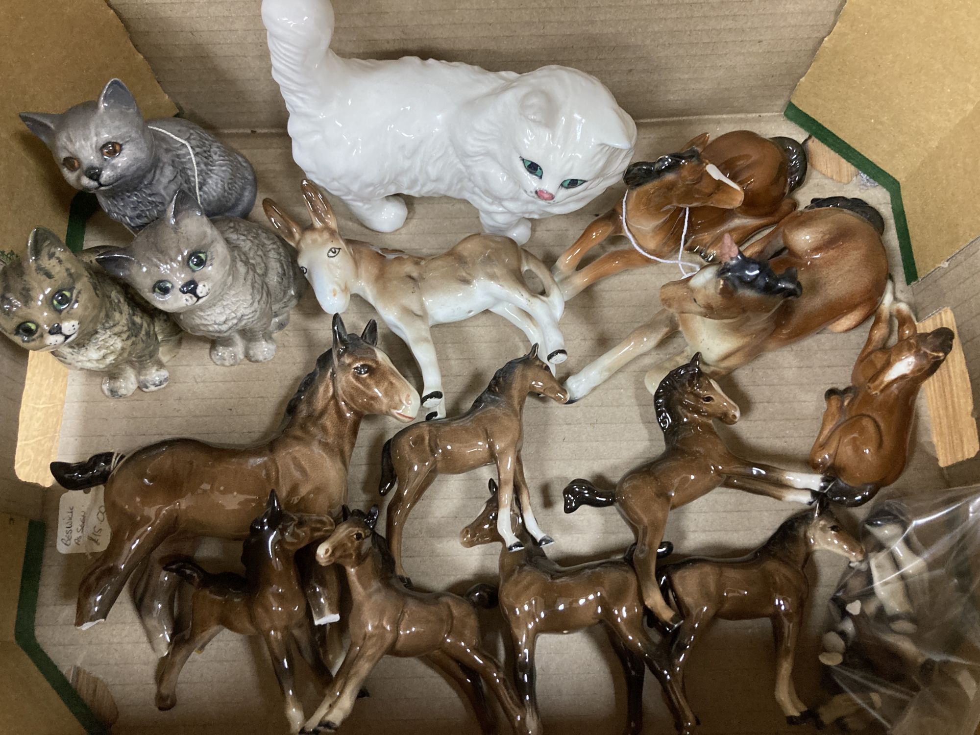 A collection of Beswick horses, cats, etc., nine with other animal ornaments